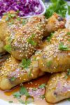 baked chicken wings with honey garlic sauce garnished with sesame seeds on plate p2
