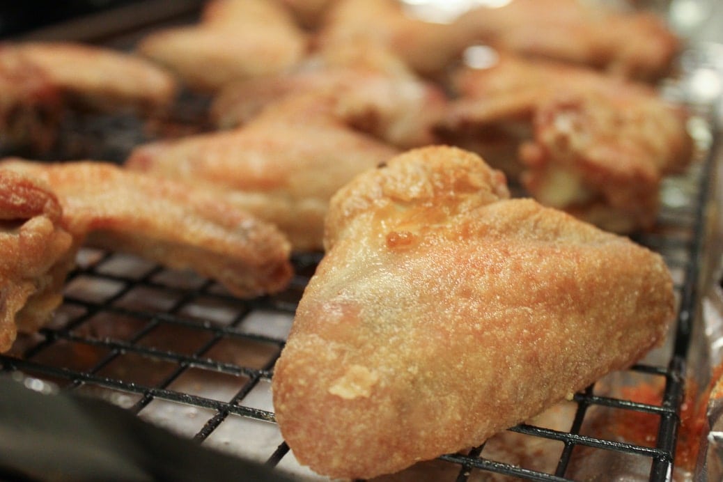 close up of baked crispy chicken wing on baking rack