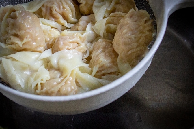 Wonton Soup wontons in strainer