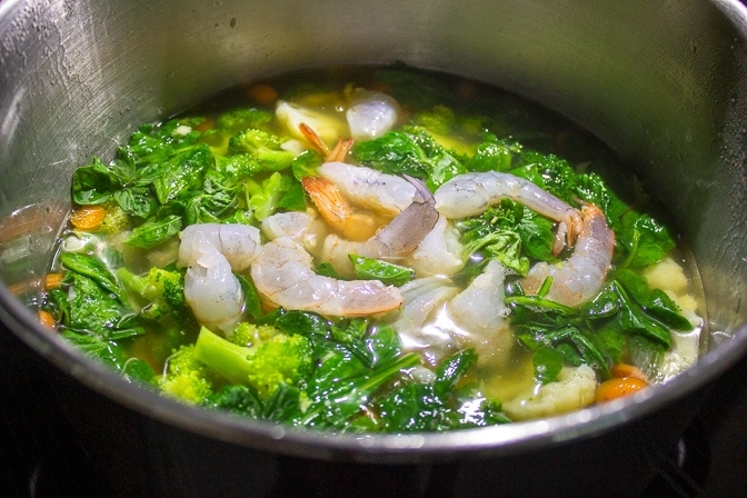 wonton soup in pot, raw shrimp added