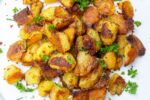 Crispy Oven-Roasted Potatoes piled on a plate fff