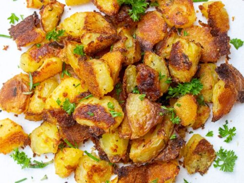Crispy Oven-Roasted Potatoes piled on a plate fff