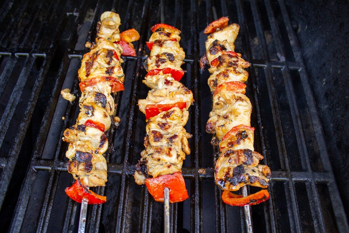 cooked chicken skewers on grill