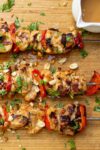 cooked chicken skewers on cutting board p1