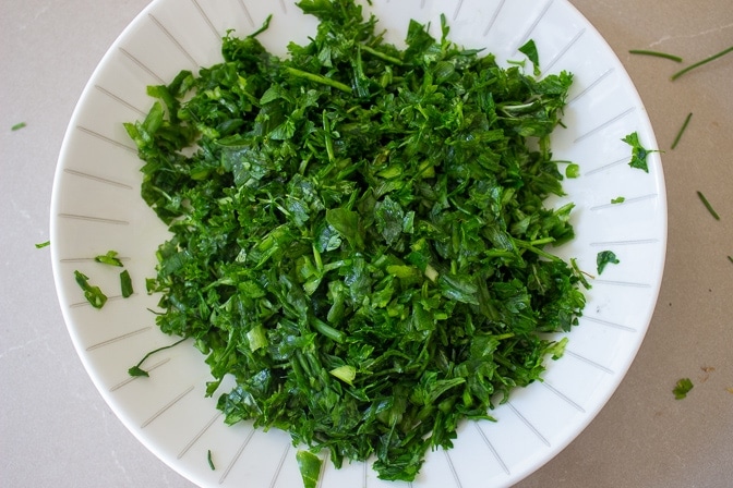 chopped fresh herbs in a bowl