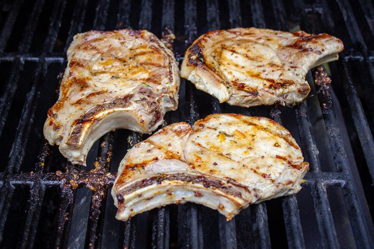 3 pork chops on grill with added marmalade