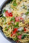 spaghetti carbonara with tomatoes and spinach in bowl p5