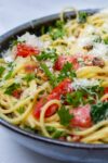 spaghetti carbonara with tomatoes and spinach in bowl p6