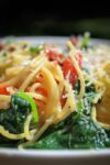 spaghetti carbonara with tomatoes and spinach in bowl p7
