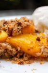 Peach Crumble on a plate with vanilla ice cream 1