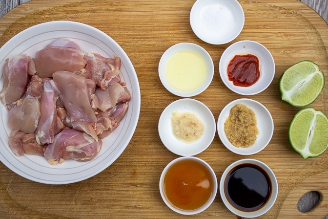 cut up boneless chicken thighs, salt, sriracha, ginger, soy, maple syrup, garlic, lime juice, lime