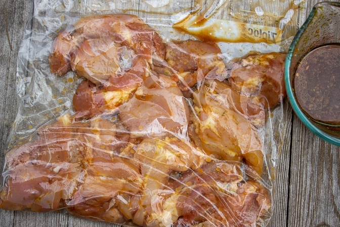 boneless chicken thighs marinating in ziploc bag