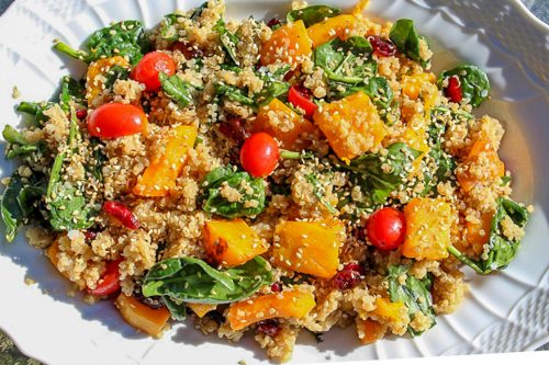 Quinoa and Butternut Squash salad in white serving bowl garnished with sesame seeds
