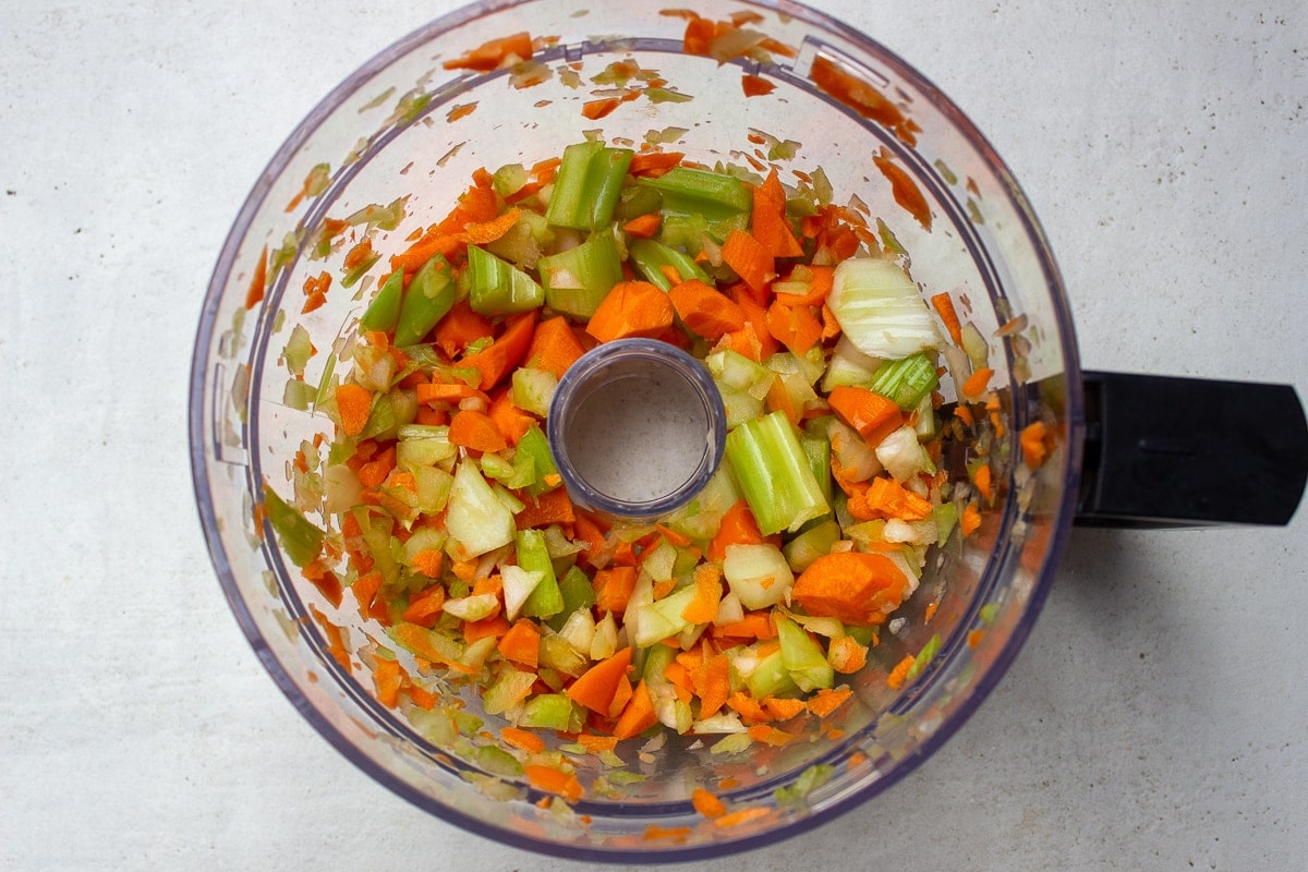 chopped celery and carrots in food processor bowl