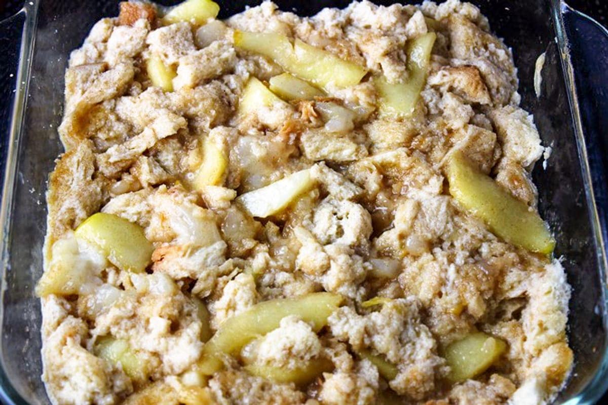 french toast casserole mixture with apples in casserole dish
