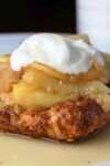 apple french toast casserole on plate with dollop of sour cream on top