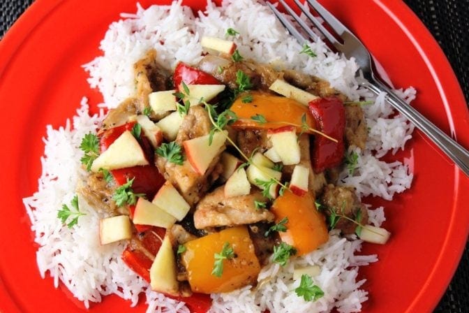 chicken stir fry with apples over rice on plate 