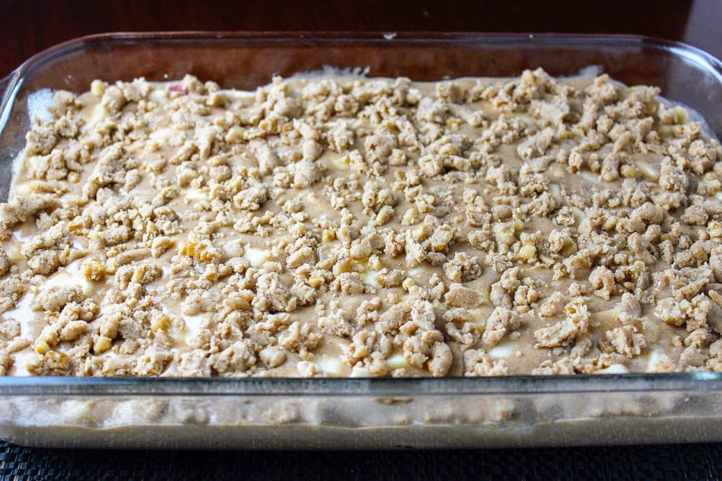 batter in cake pan topped with crumble topping