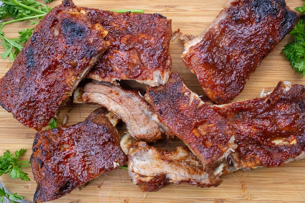 Baby back Ribs cut up on a wooden cutting board