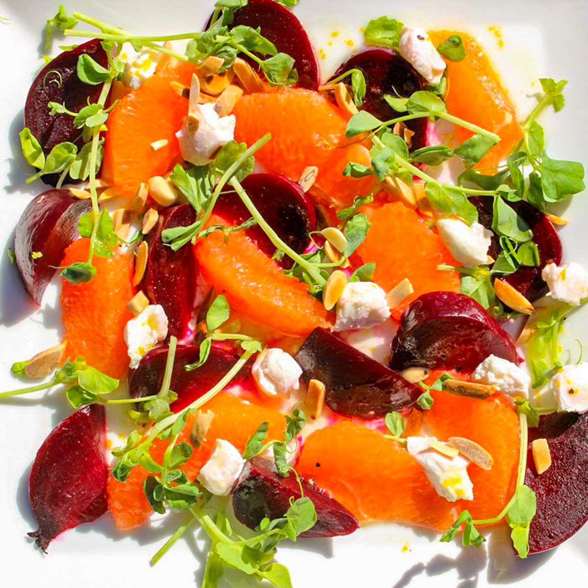 beet and orange salad with goat cheese on plate