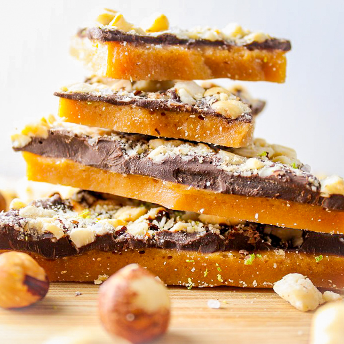 Chocolate toffee stacked on board with hazelnuts f