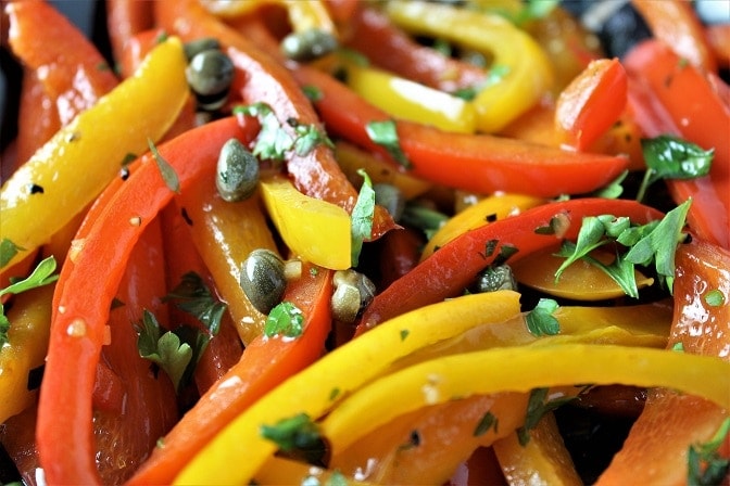 close up of sauteed peppers with caper vinaigrette in pan