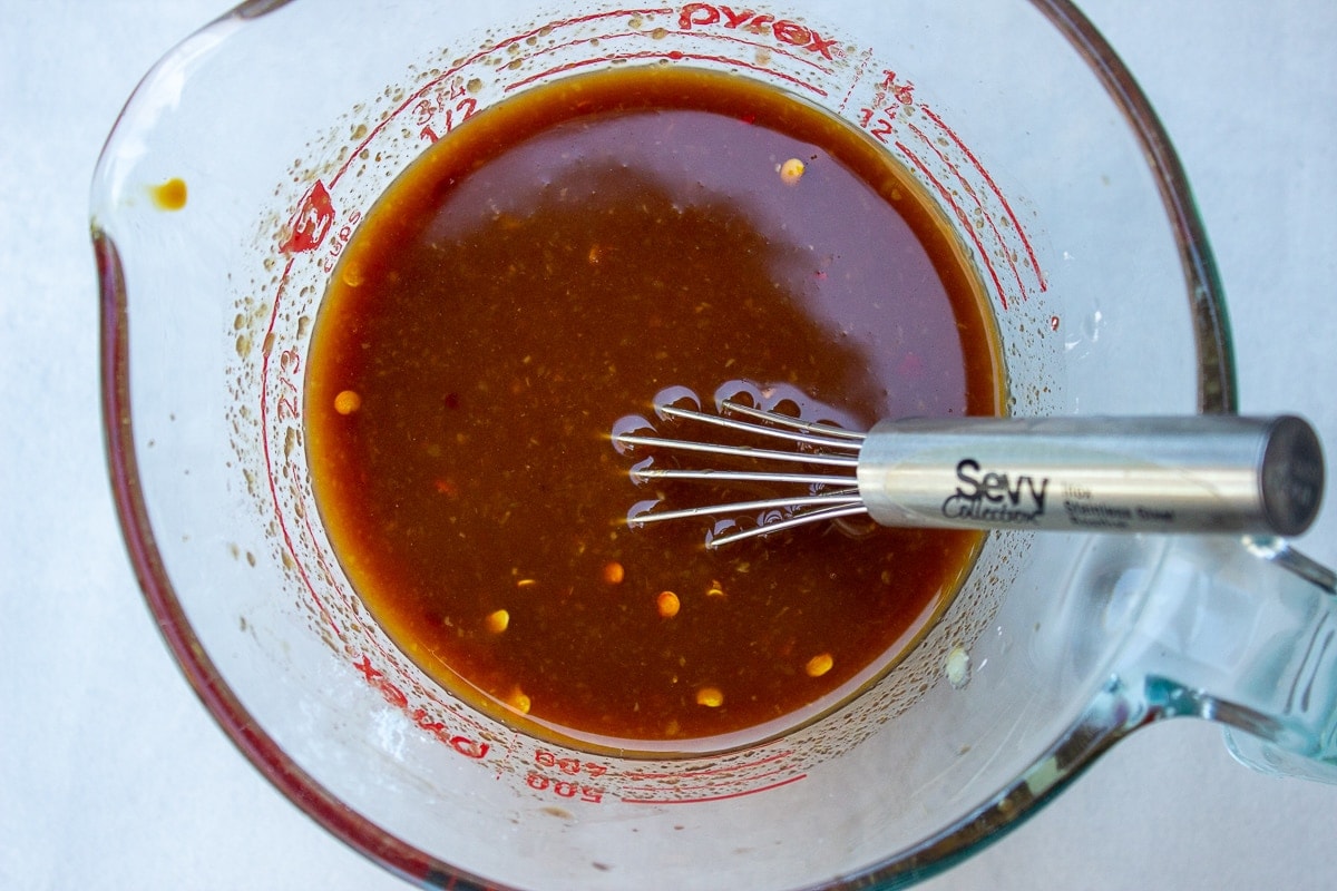 bourbon chicken sauce ingredients mixed in a measuring cup