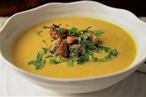 Thai-inspired butternut squash soup in bowl with garnish 5