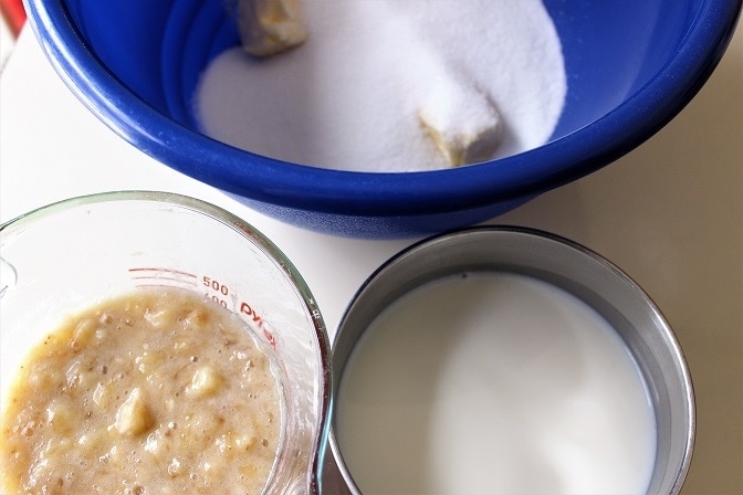 3 separate bowls of mashed bananas, wet and dry ingredients