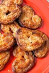 elephant ears pastries (palmiers) on a red plate p1