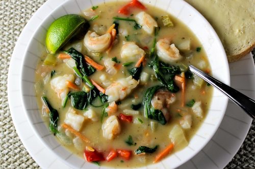 Shrimp Chowder Thai Style in a bowl with buttered bread on the side
