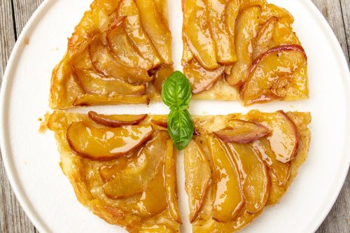 puff pastry apple tart cut into 4 slices on plate
