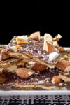 Matzo Caramel Almond Crunch pieces piled on a plate p