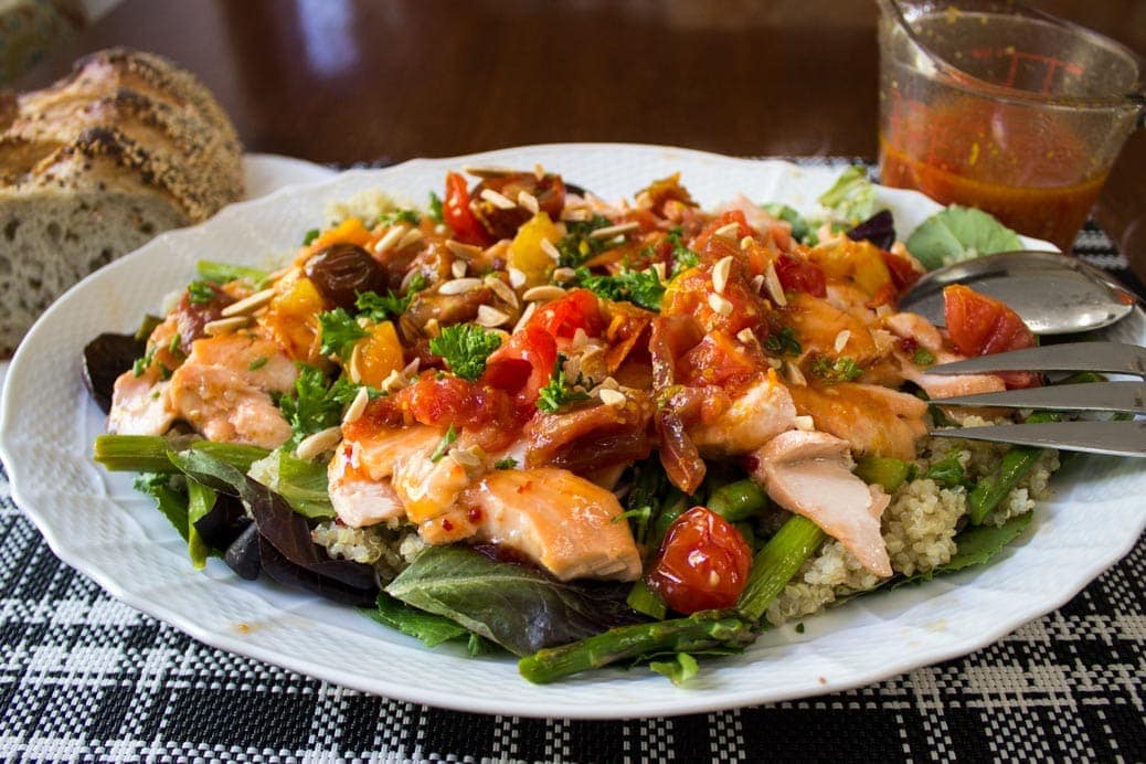 Warm Salmon Salad with Spicy Tomato Citrus Sauce made with greens, asparagus and quinoa