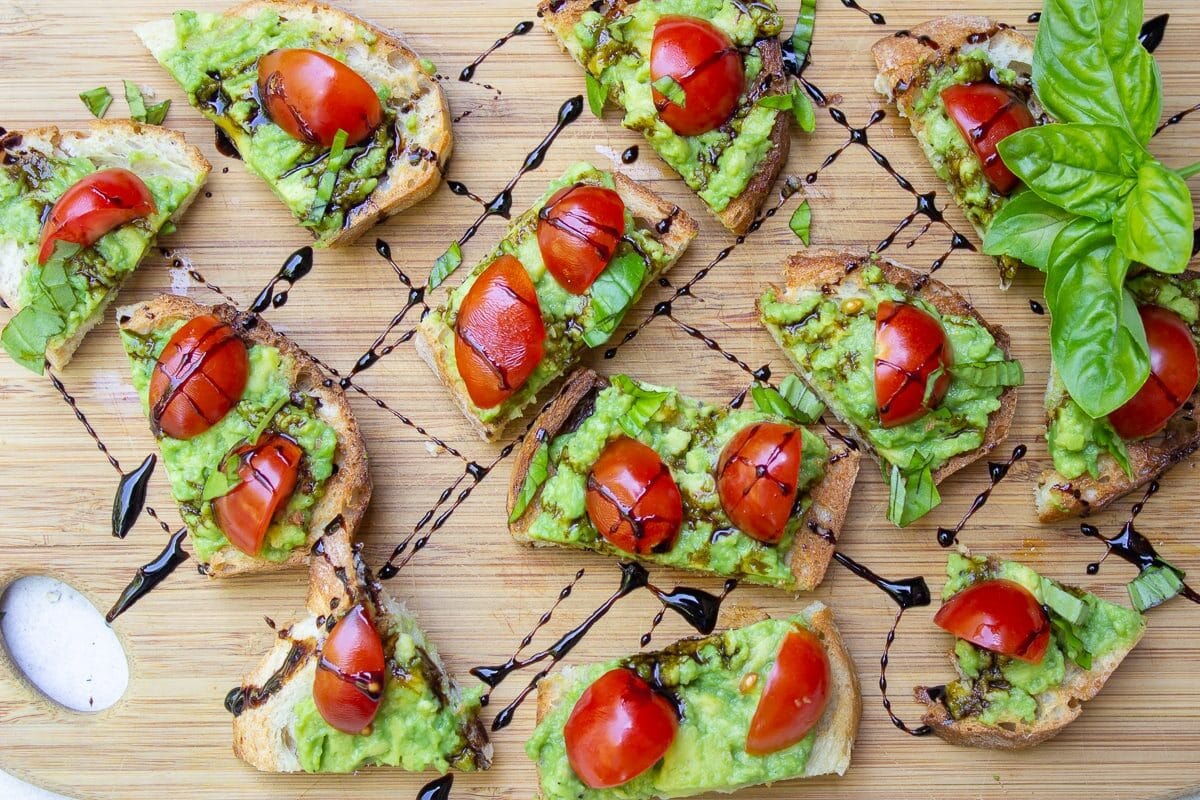 Avocado Crostini with Balsamic Drizzle on cutting board