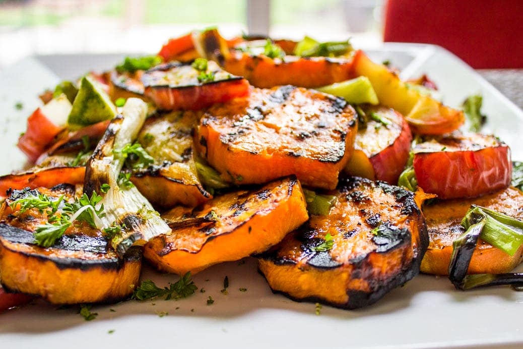 Grilled Honey-Lime Sweet Potatoes, apples and green onins on a plate f
