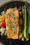 Maple Lime Salmon on black late with cherry tomatoes, quinoa and asparagus