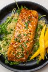 salmon filet over quinoa on plate p