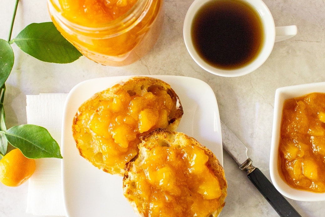 Peach Marmalade on english muffins on plate with cup of jam, coffee and jar of jam in background ff