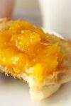 close up of peach marmalade on english muffin on plate p