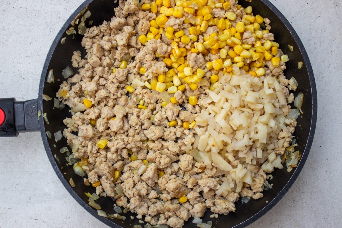 ground chicken with corn and water chestnuts in pan