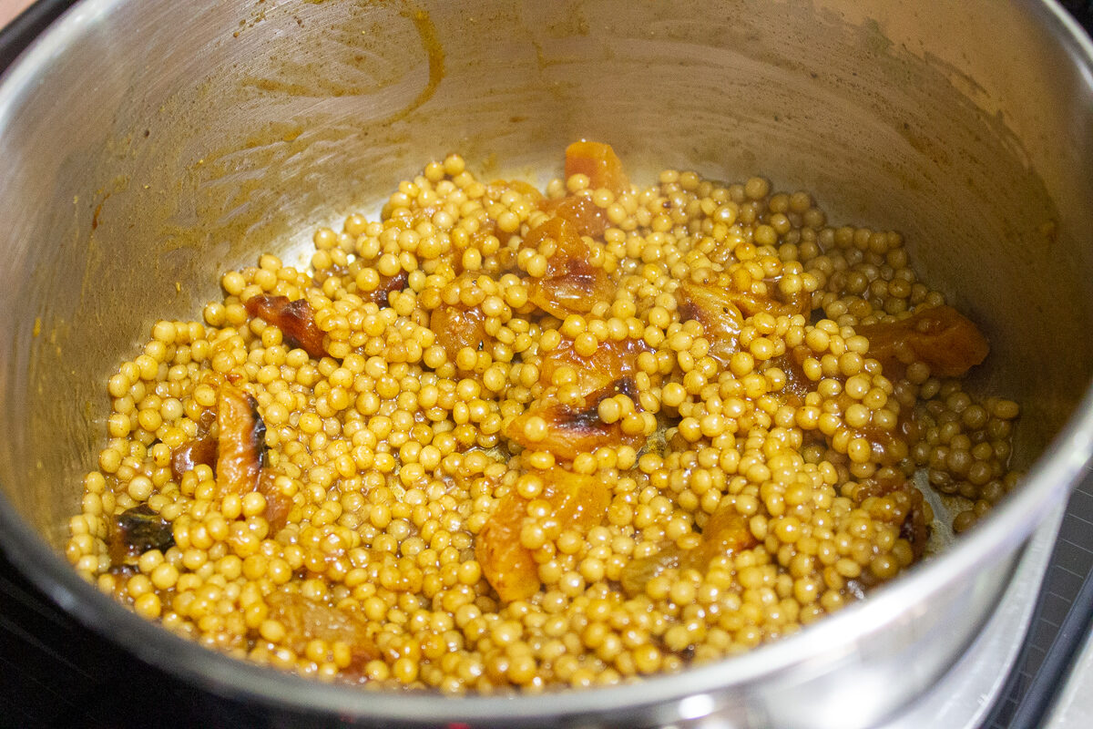 couscous and apricots in pot