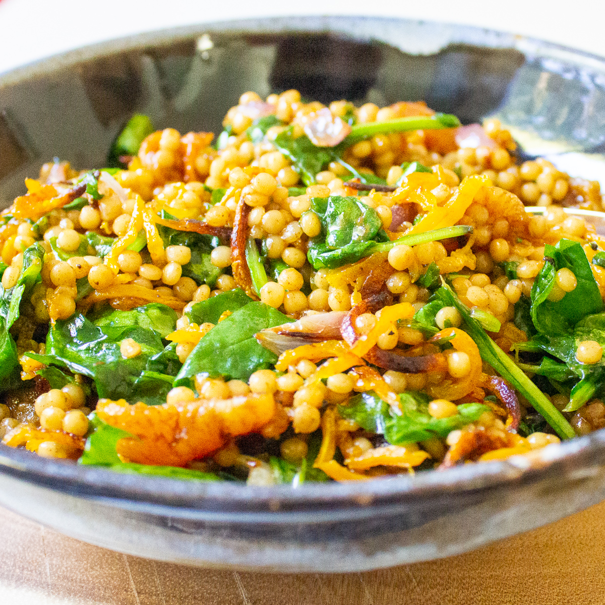 finished pearl couscous and vegetables in bowl