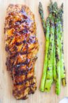 glazed pork tenderloin with asparagus on cutting board p