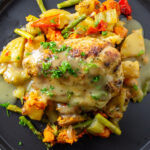 chicken and roasted veggies on plate with gravy f