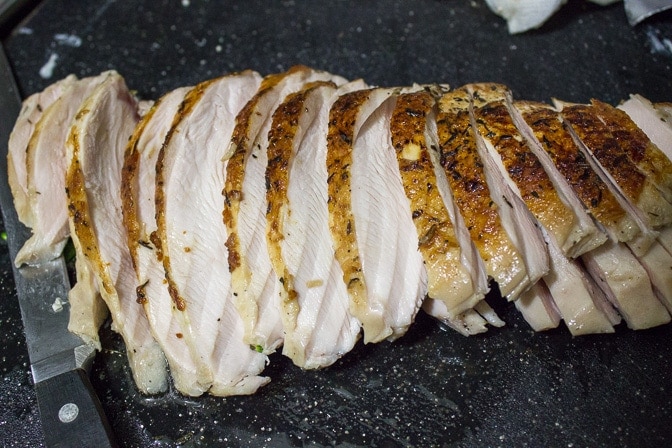 sliced sous vide turkey breast on cutting board