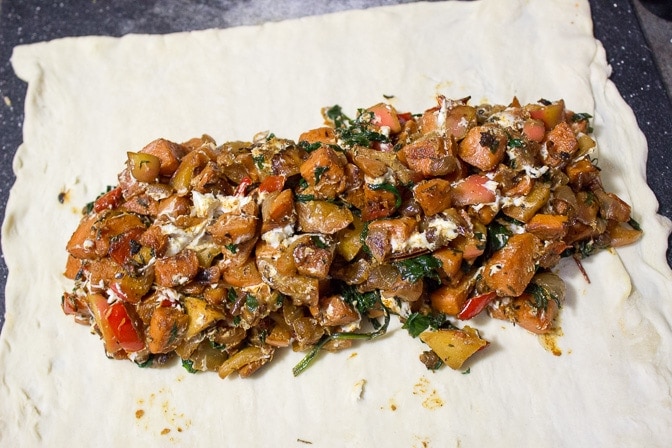 vegetable mixture on top of dough ready to be folded