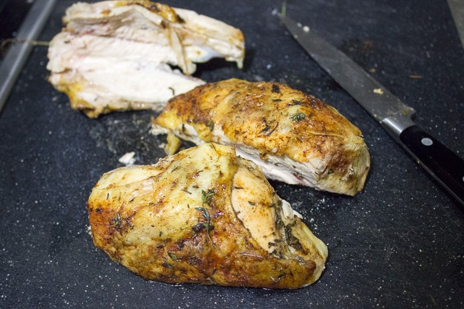 Roast Chicken Breast sliced off bone on cutting board