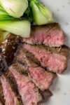 Sous Vide Flank Steak on plate with balsamic sauce and bok choy