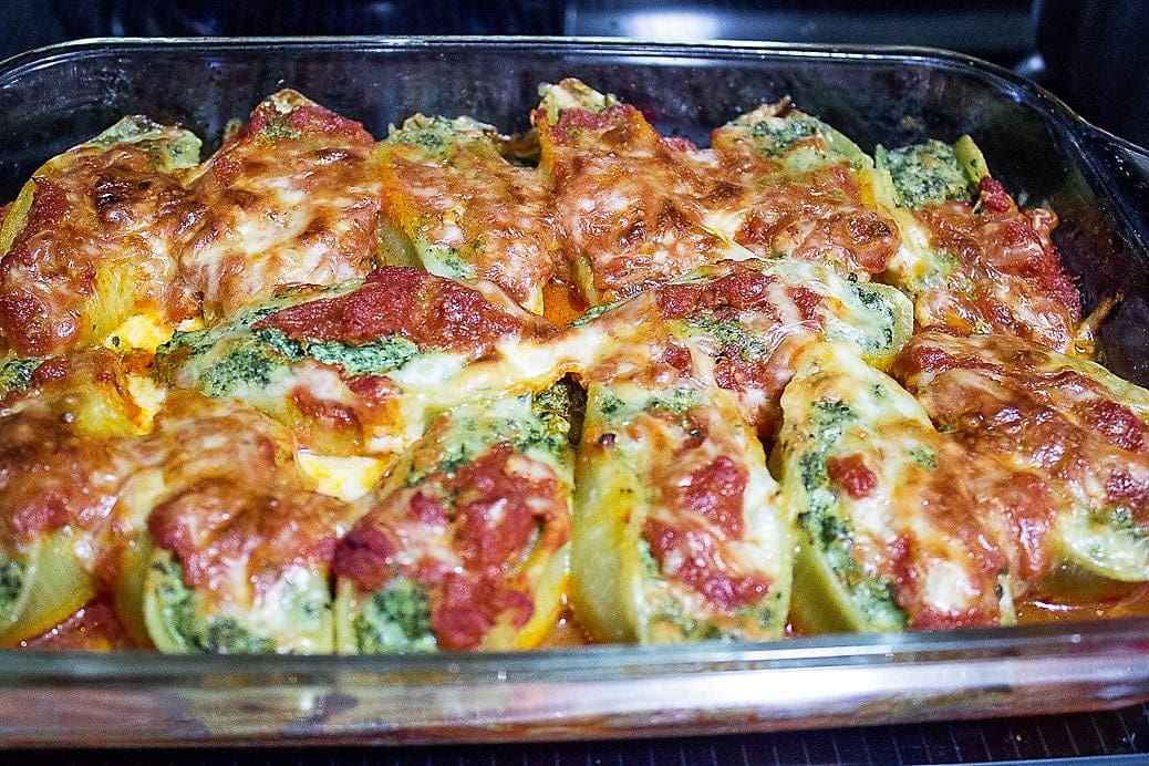 Stuffed Pasta Shells with spinach in casserole dish after baking